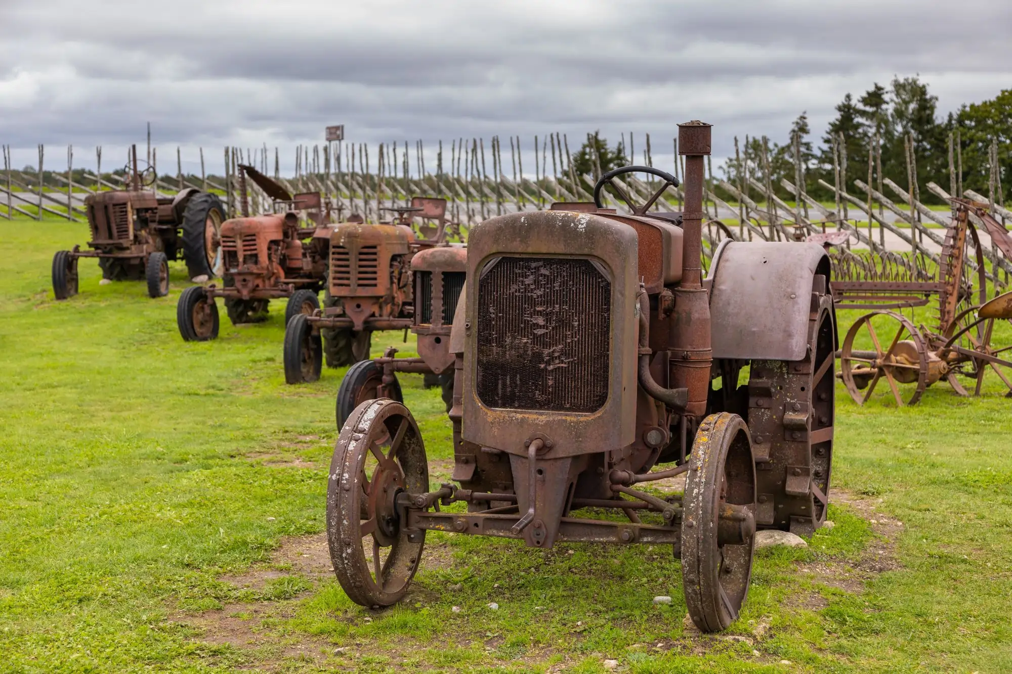 Technician performing sandblasting on heavy equipment to remove rust and old coating in Alberta